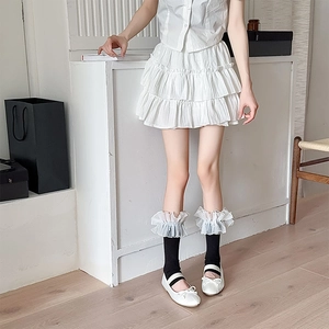 Close-up of Lolita white organza ruffled leg warmers with delicate lace trimming