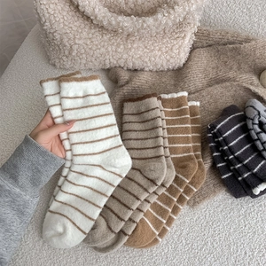 Close-up of thick striped thermal socks showing the soft fluffy texture and knit detail