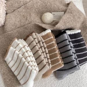 Top view of five pairs of thick striped thermal plush socks in various warm colors