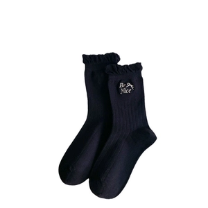Japanese style black crew socks with ruffle edge and Be Nice bow embroidery detail