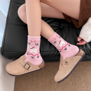Pink plush socks with cartoon dog pattern paired with beige suede clog slippers for winter