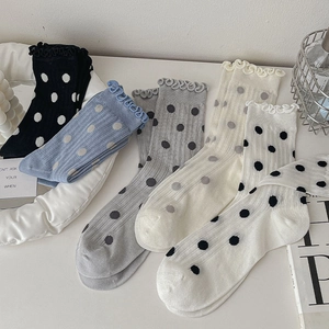 Detailed view of 5-pack polka dot crew socks with frill edges in assorted colors