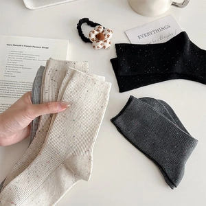 Close-up of confetti knit texture and vertical ribbing on assorted cotton mid-calf socks