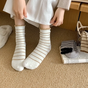 Close-up of thick striped winter thermal socks with wavy cuffs and soft plush texture