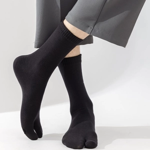 Close-up of black cotton split-toe socks with ribbed cuffs for tabi shoes and sandals