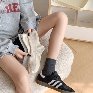Detailed knit texture and vertical stripes of cotton mid-calf socks in various colors
