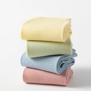 Macro detail of four pairs of candy-colored split toe socks with soft knit texture