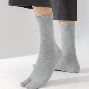 Detailed view of grey split-toe cotton socks featuring a fine ribbed knit texture
