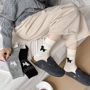 Close-up of knit crew socks with cute poodle patterns and heart textures in grey and beige