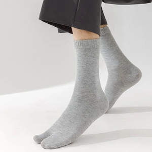 Close-up of grey cotton tabi socks with two-toe design and breathable knit texture