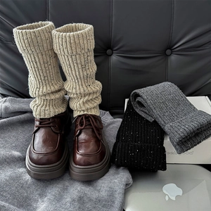 Detailed knit texture of winter leg warmers paired with vintage platform loafers