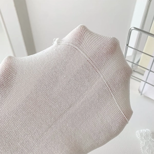 Detail of white fine mesh lace socks with breathable texture and elastic knit weave