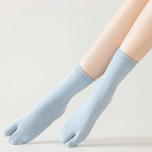 Close-up of light blue Tabi socks with a split-toe design and ribbed knit cotton cuffs