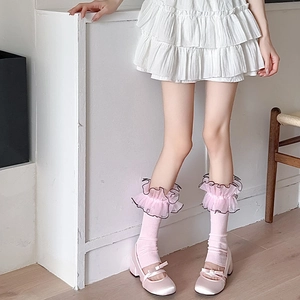 Detail of pink Lolita socks featuring ruffled lace edges and delicate black piping