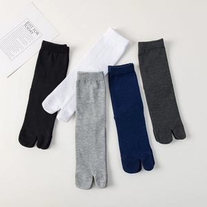 Flat lay of five color cotton tabi socks in black, white, blue and grey knit fabric