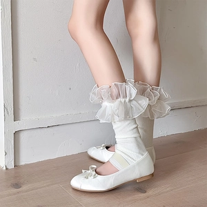 Detail view of Lolita style white organza ruffled leg warmers with pearl embellishments