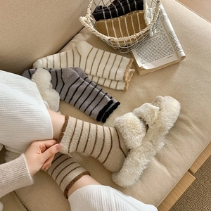 Thick striped wool socks for winter featuring cozy knit texture and neutral color tones