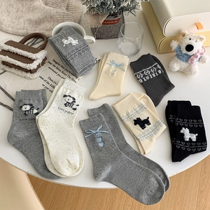 Detail of sweet mid-calf socks with cute puppy embroidery and blue ribbon bows
