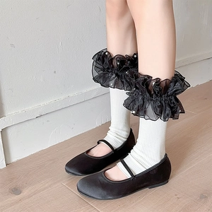 Detail of sweet Lolita leg warmers with organza ruffles and pearl bead accents