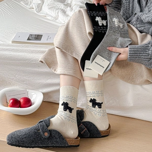 Cozy knit mid-calf socks with cute puppy pattern paired with grey felt clogs for home