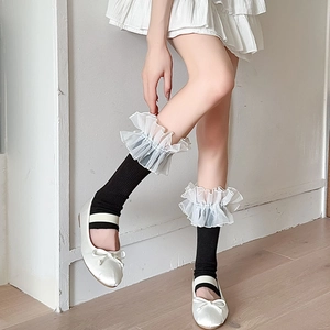 Detail of Lolita style leg warmer featuring layered organza lace and beaded ruffles