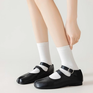 Black Tabi Mary Janes with double straps worn with white mid-calf tabi socks
