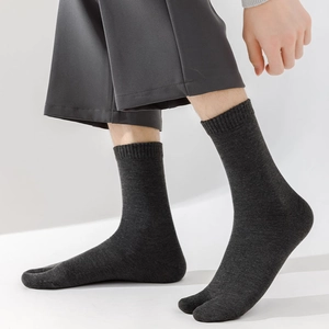 Detail view of dark grey Tabi socks showing the split-toe design and ribbed knit texture