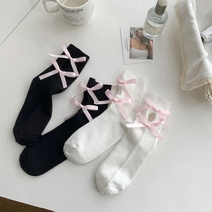 Lolita style knee high socks with hollow out details and pink bows in black and white