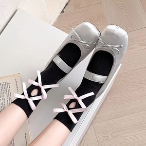 Lolita style white hollow-out knee-high socks with pink bows and ballet flats