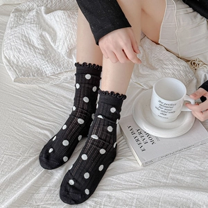 Japanese style black and white polka dot crew socks with frill trim and ribbed texture