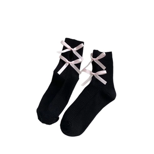 Japanese Lolita style black calf socks with pink ribbon bows and ribbed knit texture