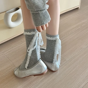 Grey Lolita mid-calf socks with white lace trim and ribbons worn with silver ballet flats