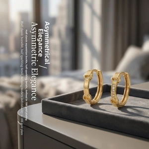 Macro shot of 18K gold plated horsebit hoop earrings with zircon micro-paving detail