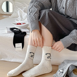Detail view of mid-calf socks with cute puppy embroidery and ribbon bow accents