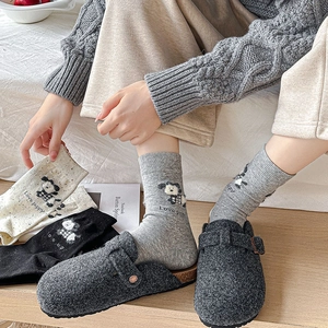 Detail of knitted mid-tube socks featuring cartoon puppy embroidery and Love puppy text
