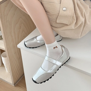 Detail of silver Mary Jane sneakers featuring breathable mesh and cute dog embroidery
