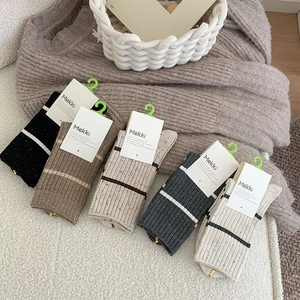 Detailed close-up of colorful flecked knit socks in five vintage autumn-winter colors