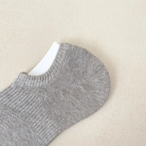Close-up of gray mesh breathable low cut sock showing heel knitting detail and texture