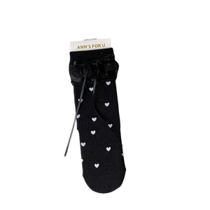 Japanese style black cotton crew socks with white heart patterns and lace bow trim