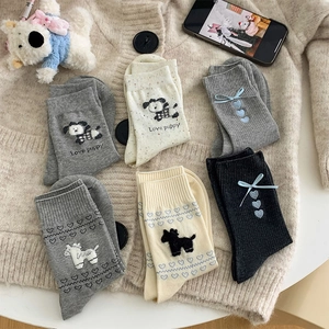 Detail of sweet ribbon bow socks featuring heart patterns and cute puppy motifs