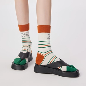 Detail of tabi socks with split toe design and orange contrast stripes on white cotton