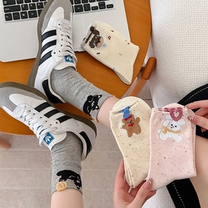 Detail showing cute bear embroidery on cotton mid-calf socks with comfortable rib cuffs
