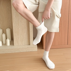 Close-up of white breathable mesh cotton ankle socks for men with vertical ribbed texture