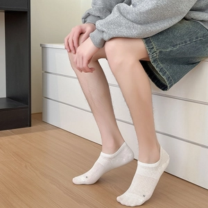 Detail of white mesh breathable no-show socks with small letter n and silicone grip