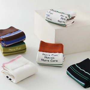 Detail of striped cotton two-toe socks with creative text prints and colorful designs