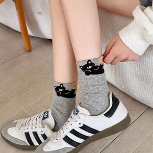 Close-up of gray cotton mid-calf socks featuring a cute cartoon cat embroidery detail