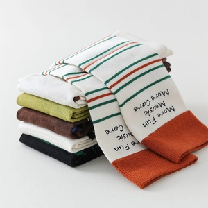 Detail of colorful striped split-toe socks with artistic text and soft knitted texture