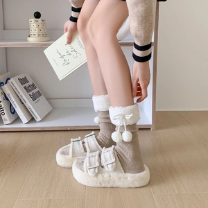 Detail of plush platform slippers with double straps and fuzzy calf socks in cream and brown
