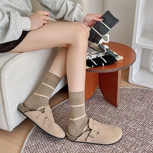 Japanese style striped crew socks paired with beige suede buckled flat mules for women