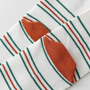 Close-up of striped cotton tabi socks with green stripes and orange heel contrast